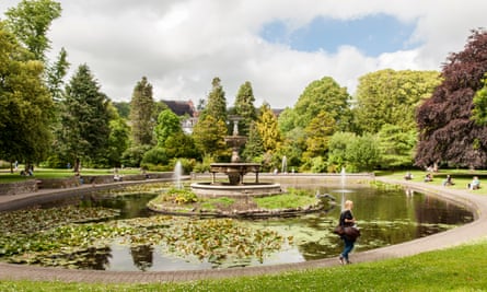 Young woman walks past the fountain in Fitzgerald’s Park Cork