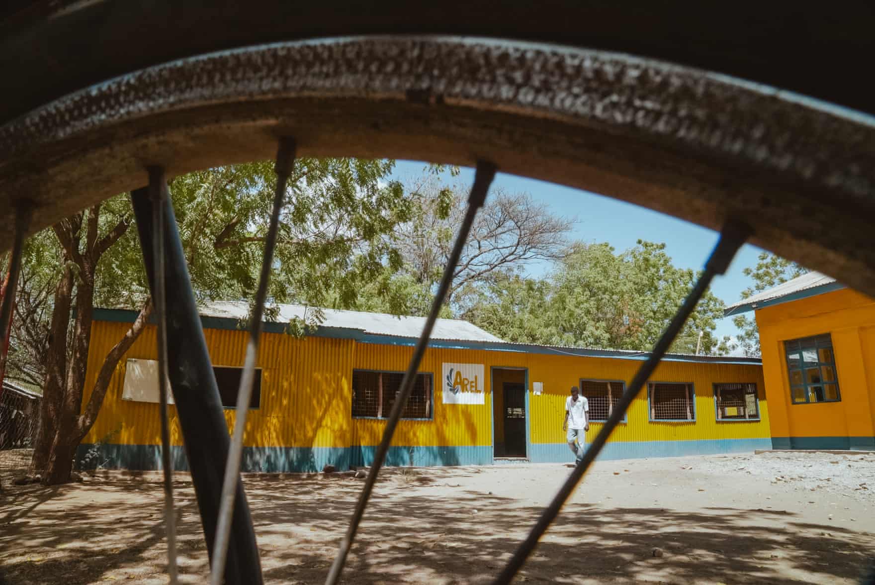 Exterior view of a yellow-walled compound.