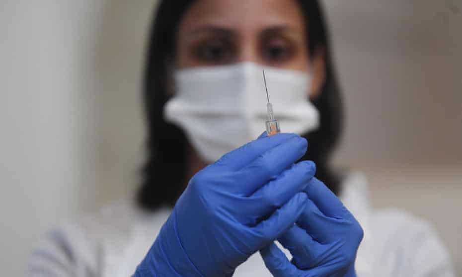 A member of clinical staff prepares the AstraZeneca Covid19 vaccine at an NHS centre in Ealing, London.