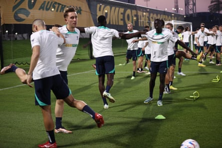 Socceroos players lean on each other during a training session at the Aspire Academy in Doha, Qatar.
