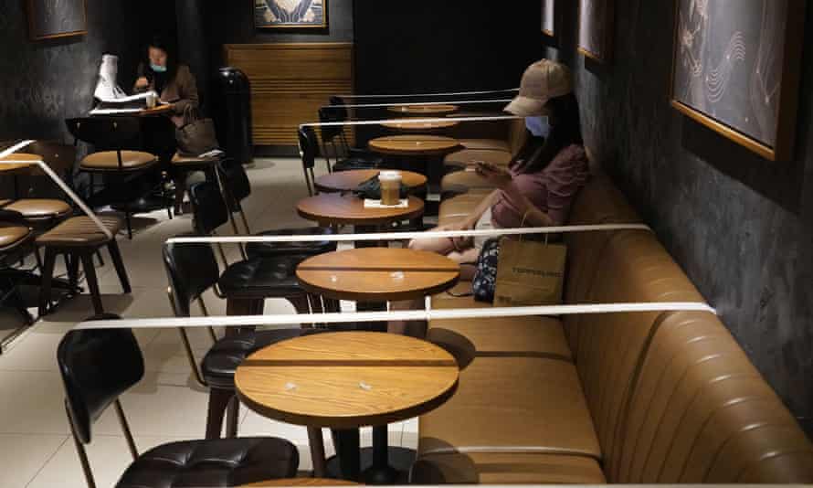 Tables and chairs are taped to ensure social distancing at a Starbucks coffee shop in Hong Kong, 30 March 2020.