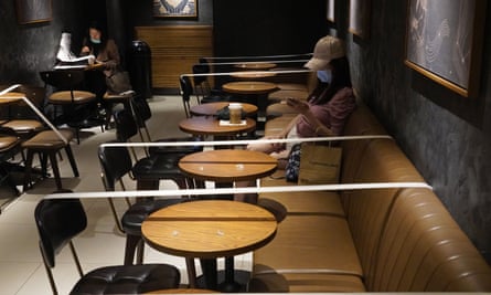 Tables and chairs are taped to ensure social distancing at a Starbucks coffee shop in Hong Kong, 30 March 2020.