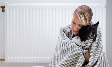 Woman cuddling dog by radiator