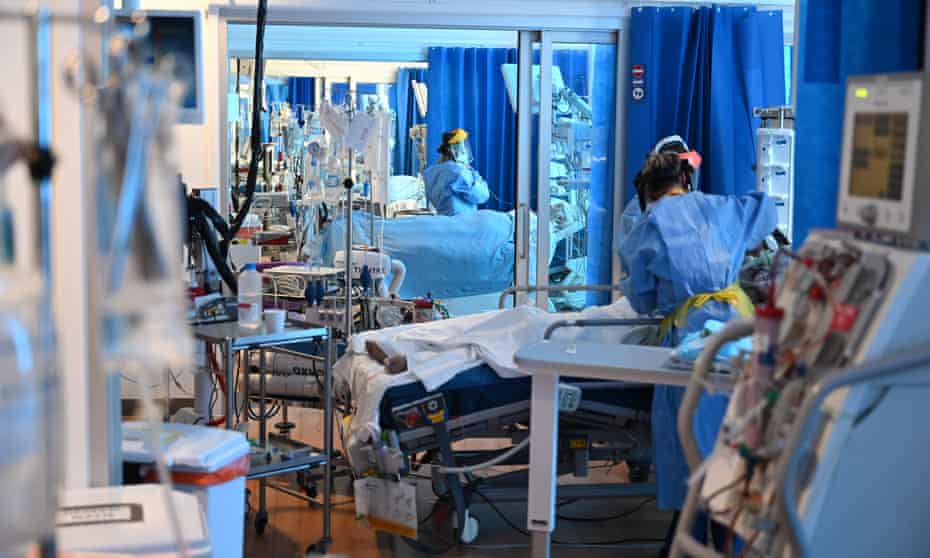Clinical staff wear PPE at an intensive care unit in England.