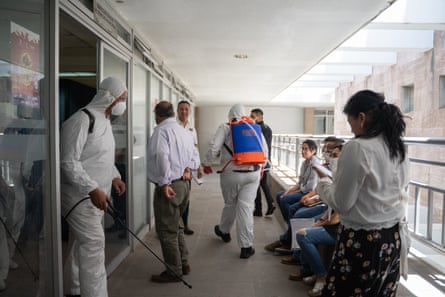 Council staff wait outside their offices while the building is cleaned in April 2020.
