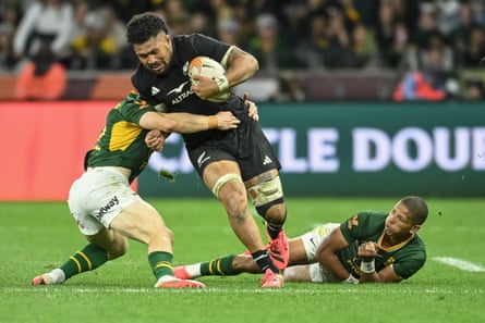 New Zealand’s No 8 Ardie Savea is tackled by the South Africa scrum-half Morne van den Berg.