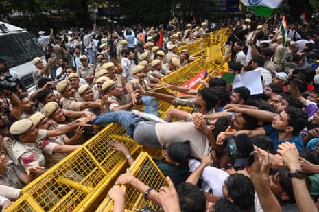 Protesters face police as they try to mount a barrier