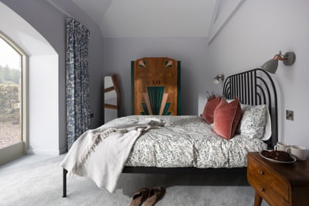 Bedroom with old wardrobe and large window on the left