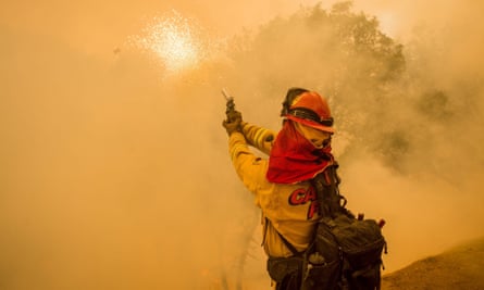 Cal Fire Captain Josh Kitchens fires a flare gun to ignite a backfire while battling the Rocky fire near Clearlake, California on Sunday. 