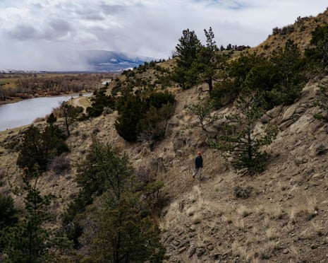 A woman hikes near a home