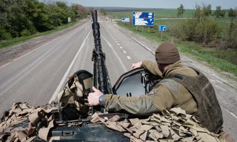 A Ukrainian soldier sits on an armoured personnel carrier in eastern Ukraine.