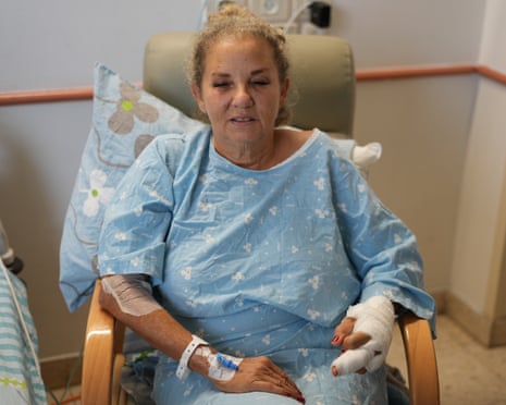 Heidi Levine wearing a gown and sitting in a chair with a heavily bandaged left hand