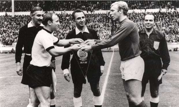 Uwe Seeler and the England captain Bobby Moore exchange pennants ahead of the 1966 World Cup final at Wembley.