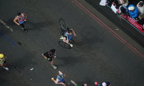 Ben Kellett carries his bike as he crosses Tower Bridge