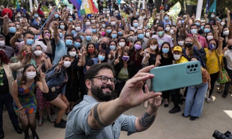 Gabriel Boric takes a selfie with members of his electoral campaign and supporters after presenting his government program in Santiago on 1 November.