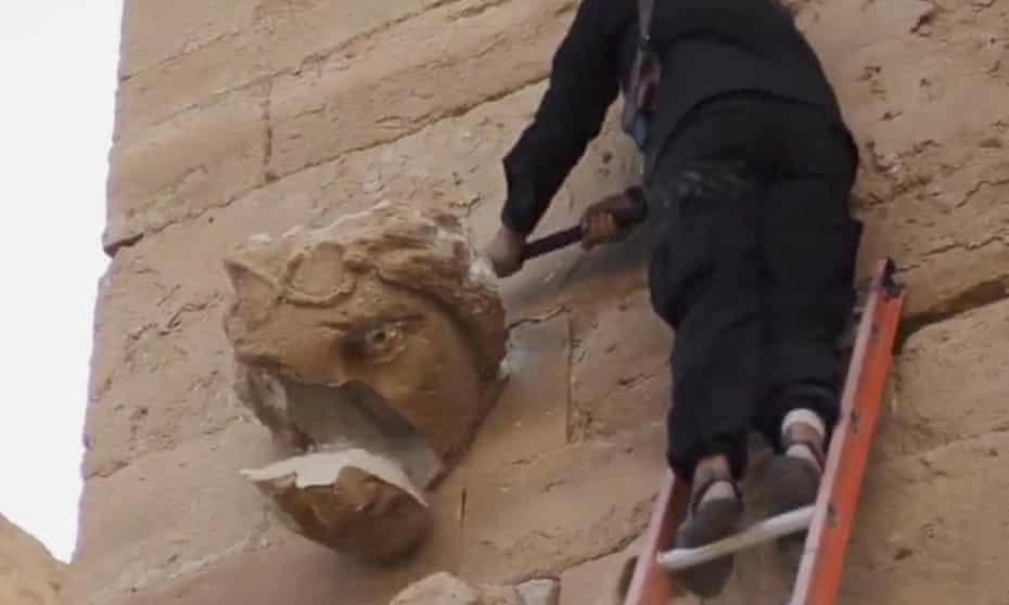 A still from the Isis video posted on YouTube shows a militant attacking an artefact with a sledgehammers