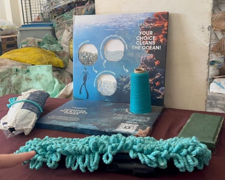 Blue rope tied up with bales of plastic bottles behind