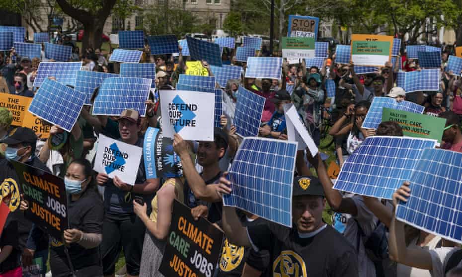 Activists display prints replicating solar panels during a rally to mark Earth Day in Washington, USA