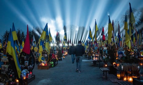 Citizens and families of Ukrainian militaries who killed during Russia-Ukraine war, take part in a ceremony to honor the memory of fallen soldiers on the eve of the 3nd anniversary of the Russian-Ukrainian war, where 'rays of remembrance' are lit into the sky above the Lychakiv Cemetery in Lviv, Ukraine, February 23, 2025.
