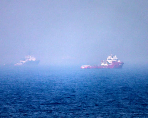 Ships sail near the strait of Hormuz off the eastern coast of the United Arab Emirates at Khor Fakkan on 13 July