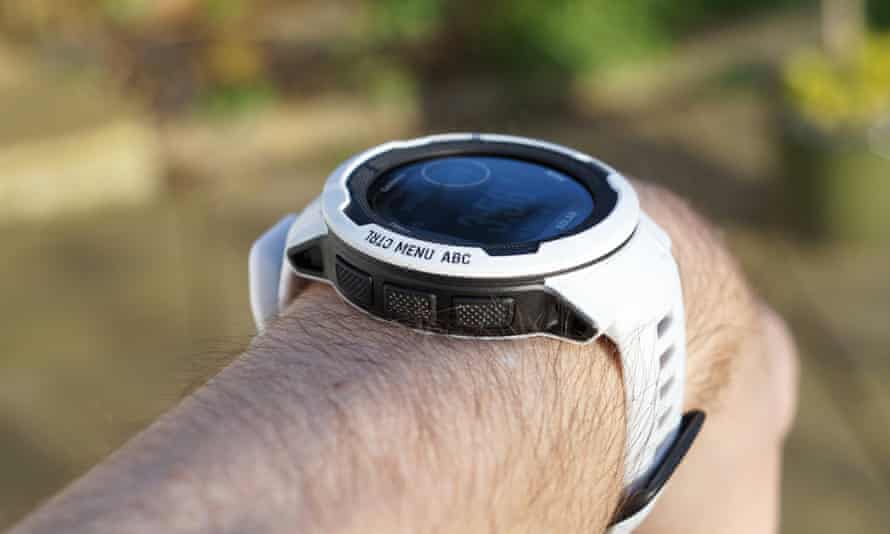 The Instinct 2 in mist grey shown on a man’s wrist.