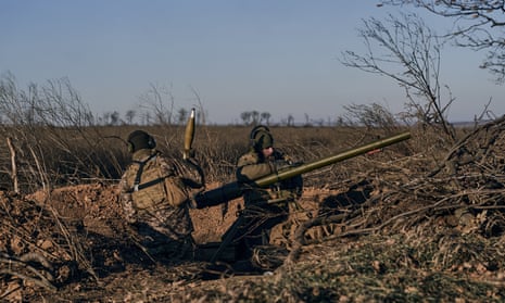 Ukrainian soldiers fire a cannon at Russian positions on the frontline near Bakhmut, Donetsk region, Ukraine, on Tuesday