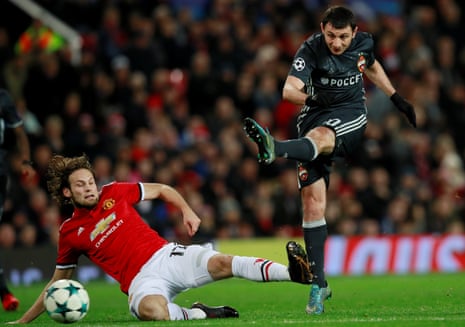 Daley Blind slides in to try and block the shot from Alan Dzagoev.