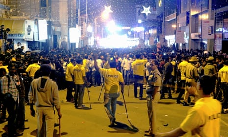 Indian police attempt to manage crowds during New Year’s Eve celebrations in Bangalore