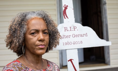 Lydia Gerard in front of her house in Reserve, next to a memorial for her late husband, Walter Gerard who died in 2018.