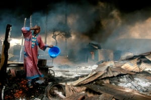 A man rinses soot from his face at the scene of a gas pipeline explosion near Nigeria’s commercial capital Lagos 26 December, 2006. Up to 500 people were burned alive when fuel from a vandalised pipeline exploded in Nigeria’s largest city, Lagos