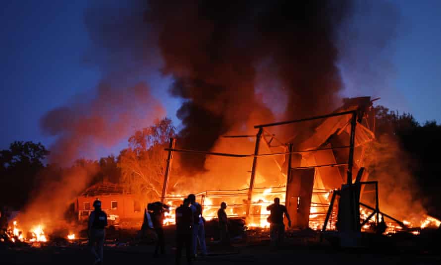 Flames rise from a structure after it was hit by a projectile on 20 June in Druzhkivka,
