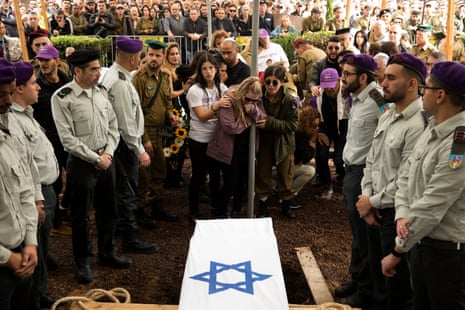 Family and friends mourn during a funeral for Adir Portugal in Mazkeret Batya, Israel.