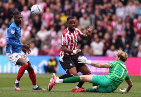 Cyle Larin of Southampton is challenged by Pompey keeper Nicolas Schmid
