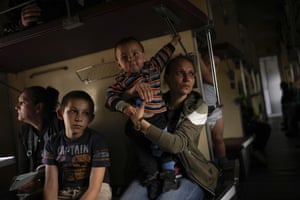 Yana Skakova and her son Yehor who fled from Lysychansk sit in an evacuation train at the station in Pokrovsk