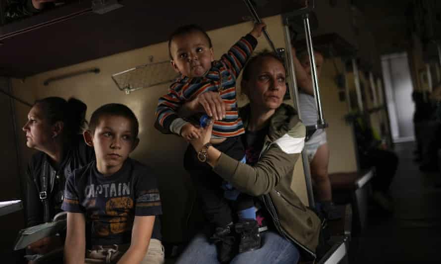 Yana Skakova and her son Yehor who fled from Lysychansk with other people sit in an evacuation train at the train station in Pokrovsk, eastern Ukraine, eastern Ukraine, Saturday, May 28, 2022.