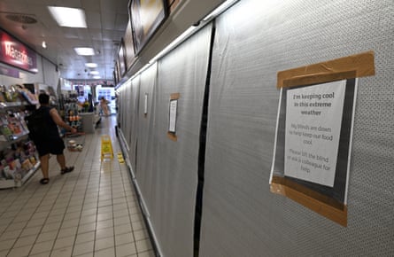 Blinds cover the fridges on a supermarket aisle