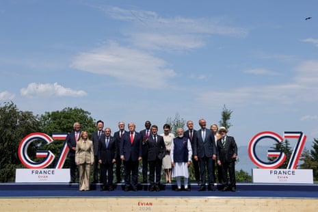 G7 leaders and guests pose for a family photo during the G7 summit, in Evian-les-Bains, France.