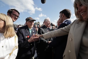 The French president, Emmanuel Macron, and his wife, Brigitte, shake hands with US D-Day veteran Steven Melnikoff in Saint-Lô, France