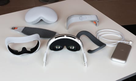 Various detached parts of the Vision Pro laid out on a table.