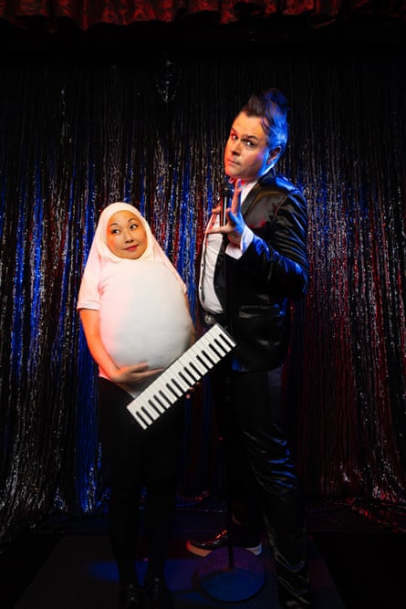 Sachie dressed as an egg and wearing a keyboard with Trent in rockabilly attire