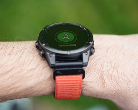 A Garmin Fenix 8 Pro, worn on a wrist, sending messages via satellite.