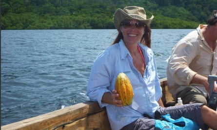 Tamara Romanuk in a boat holding an exotic fruit