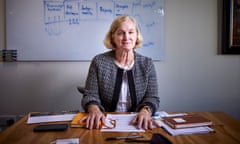 Amanda Spielman at desk with papers in front of her and whiteboard behind