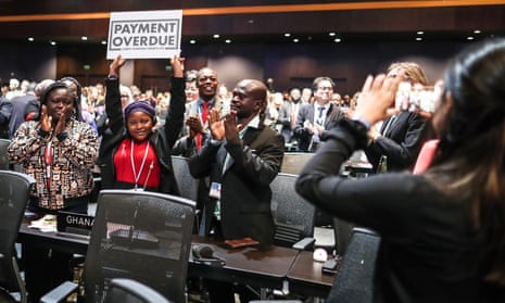 Nakeeyat Sam Dramani, a young poet from Ghana, holds a placard after giving a speech about global warming.