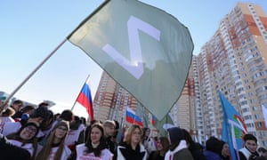 Rally in support of Russian troops on Crimea’s annexation anniversaryepa09833405 A person waves a flag with the letter Z during a rally in support of Russian Armed Forces organized to mark the 8th anniversary of the annexation of Crimea by the Russian Federation, in Krasnogorsk, Moscow region, Russia, 18 March 2022. The letter Z, painted on Russian military vehicles in Ukraine, has quickly become a symbol of support for what the Kremlin refers to as a ‘special military operation’ being carried out on Ukrainian soil. EPA/MAXIM SHIPENKOV