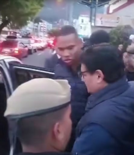 Politician with security staff next to his vehicle