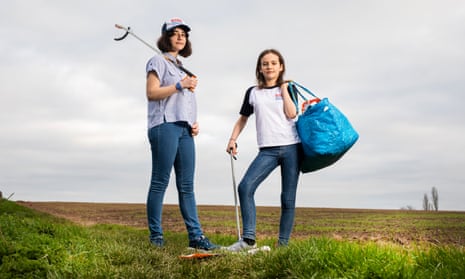 Young climate activists Amy (on left) and Ella Meek, litter-picking in fields in Nottinghamshire