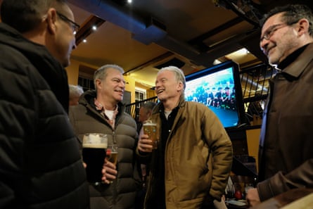 Four middle aged men in a pub laughing