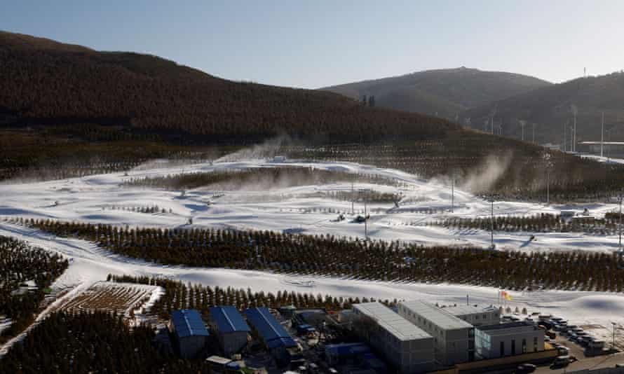 Snow guns operating on slopes near the National Ski Jumping Centre during a government-organised media tour to Beijing 2022 Winter Olympics venues in Zhangjiakou, Hebei province, China, on 21 December 2021.