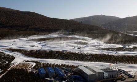 Snow guns operating on slopes near the National Ski Jumping Centre during a government-organised media tour to Beijing 2022 Winter Olympics venues in Zhangjiakou, Hebei province, China, on 21 December 2021.